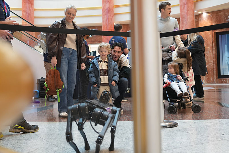 Visitors enjoying a robot dog